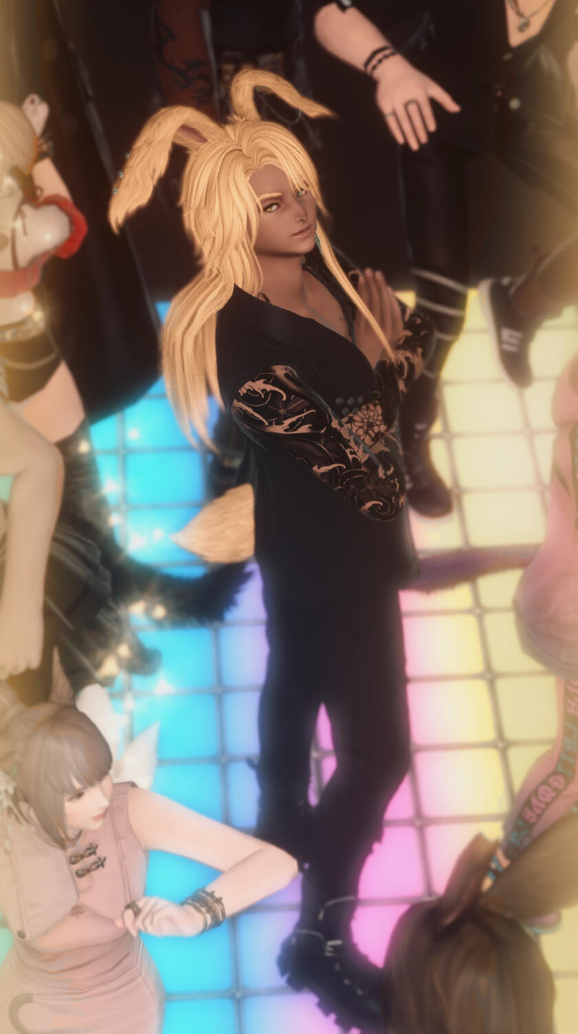 Apollo standing in the middle of a dancefloor surrounded by others, looking up at the camera with a knowing and almost smug look.